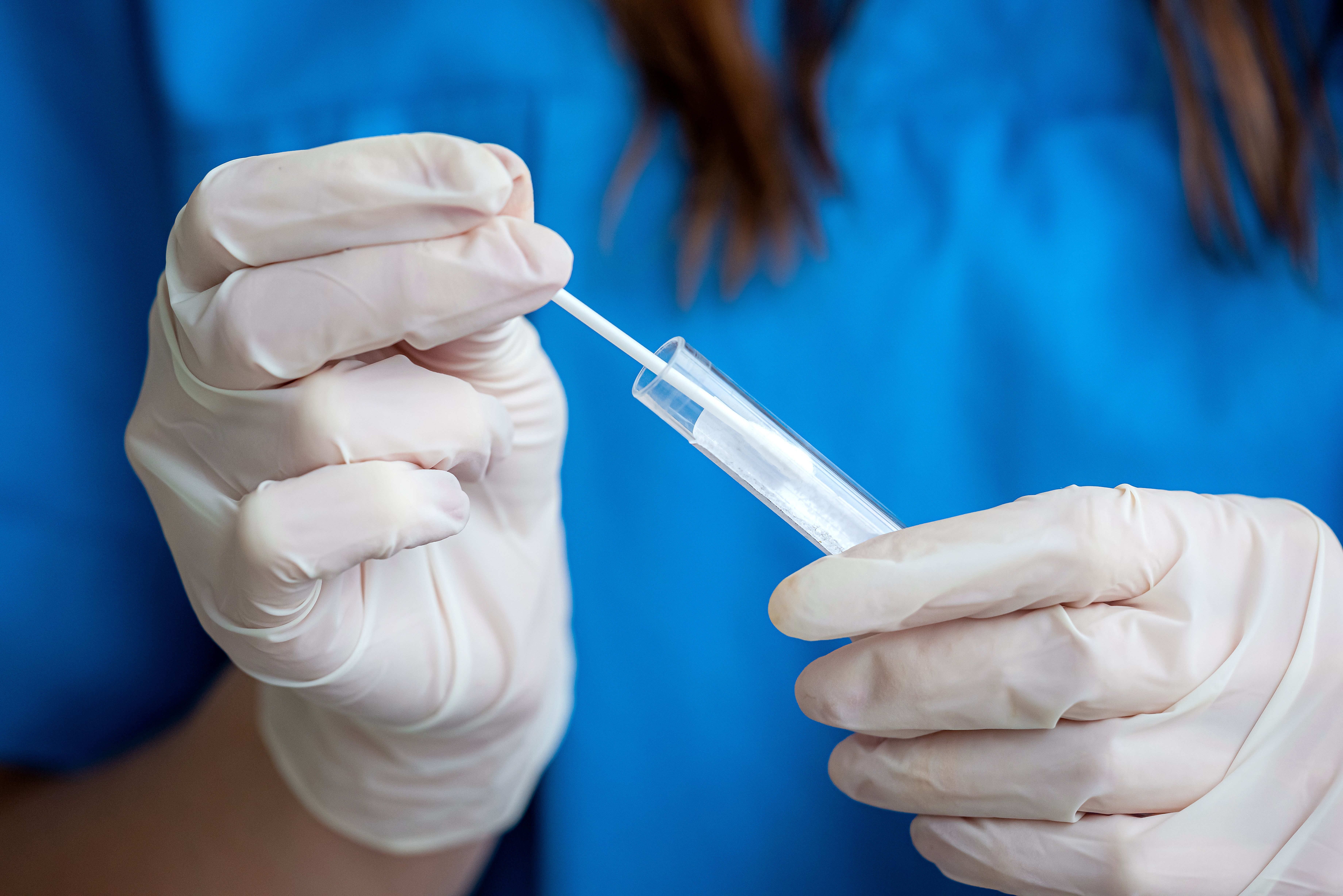 Health care worker testing a nasal swab
