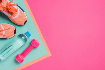 Flat lay with sport equipment on pink background