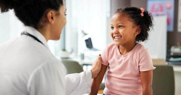 Pharmacist with a pediatric patient -- Image credit: Lawrenson25/peopleimages.com | stock.adobe.com