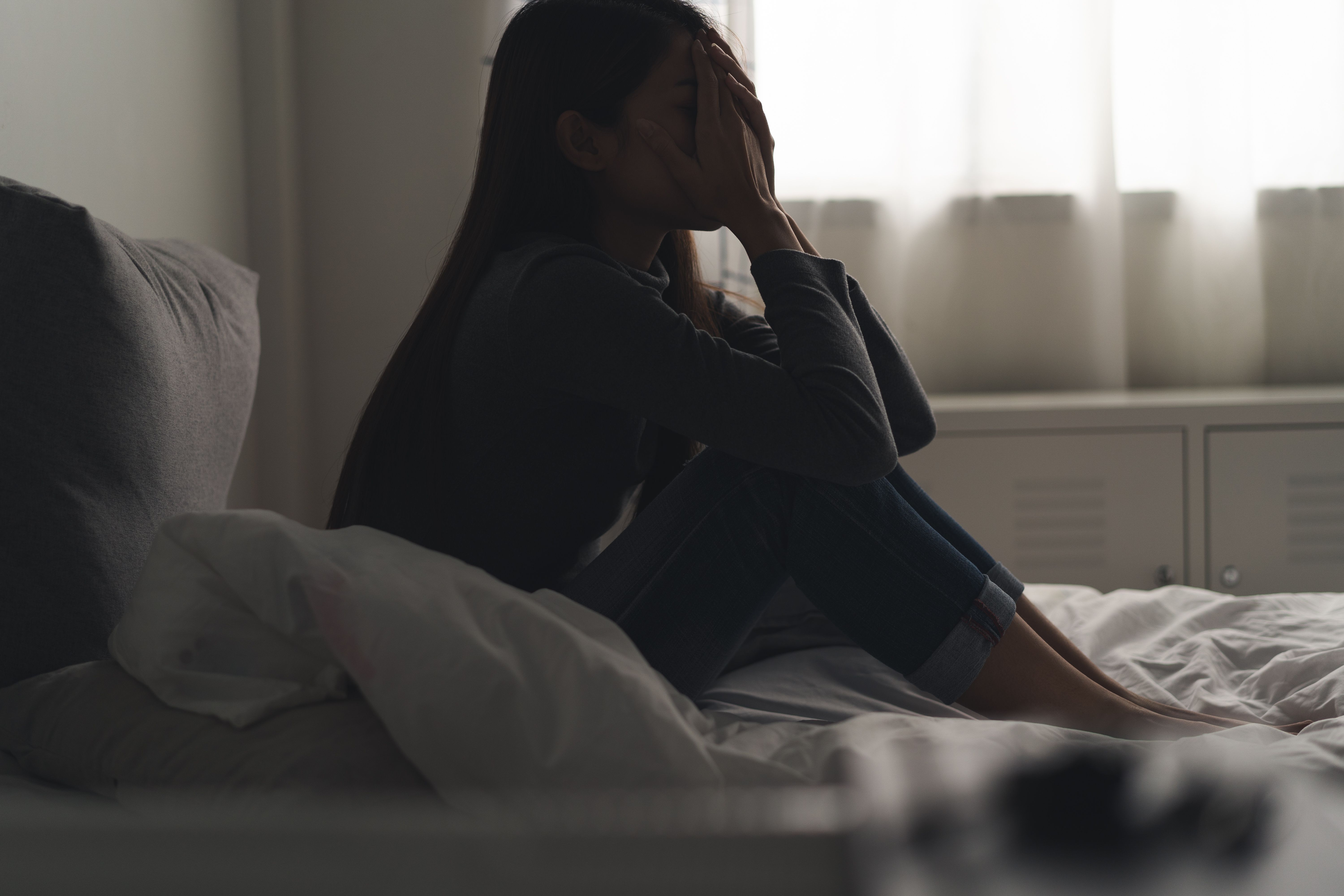 Woman dealing with depression -- Image credit: Pormezz | stock.adobe.com