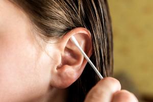 Woman cleaning ear with cotton swab. Hygiene ears | Image Credit: © Natallia - stock.adobe.com