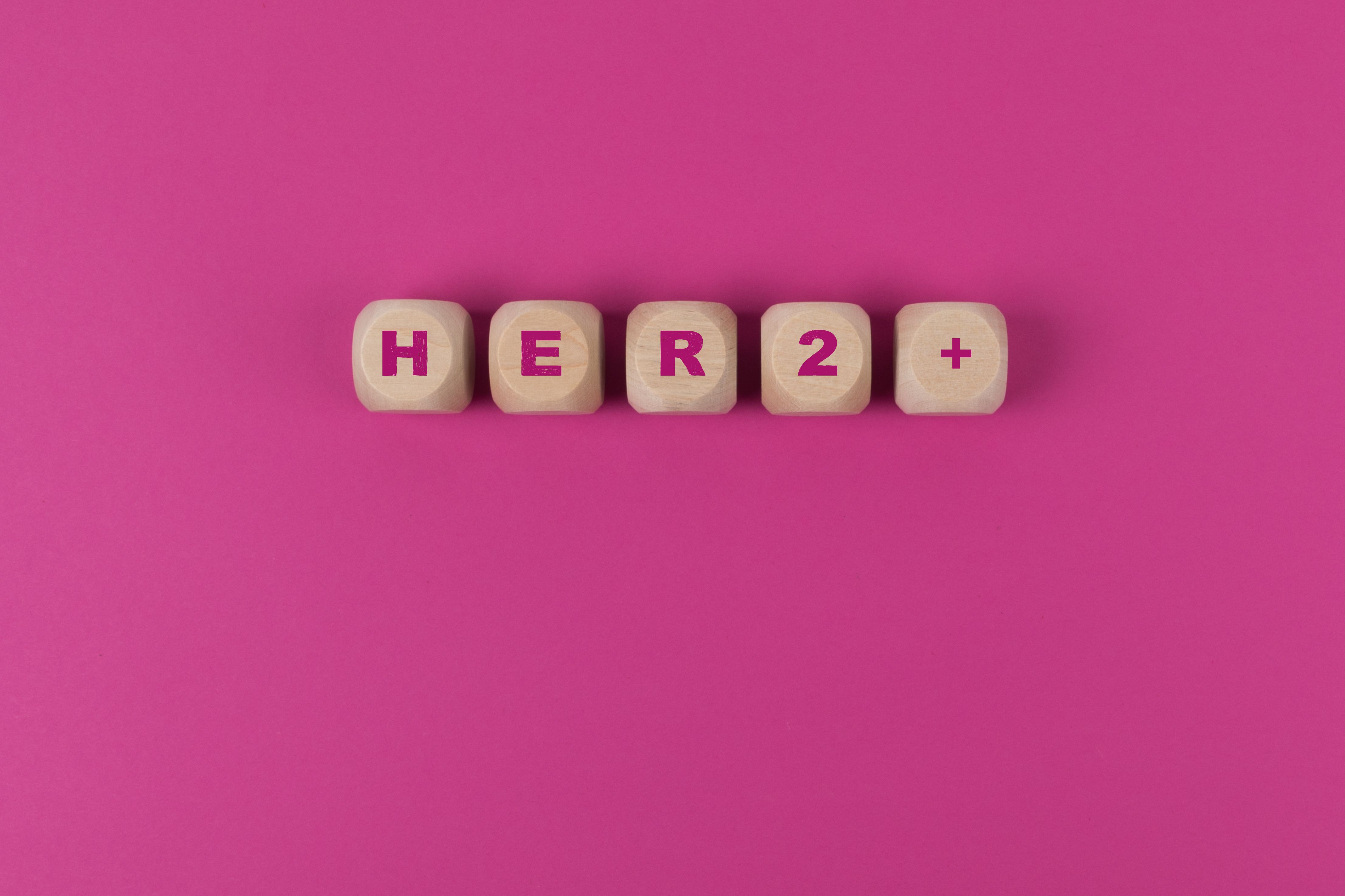 Wooden blocks spelling HER2+ | Image Credit: © AnnJane - stock.adobe.com