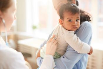 Female doctor examining infant patient | Image Credit: © AnnaStills - stock.adobe.com