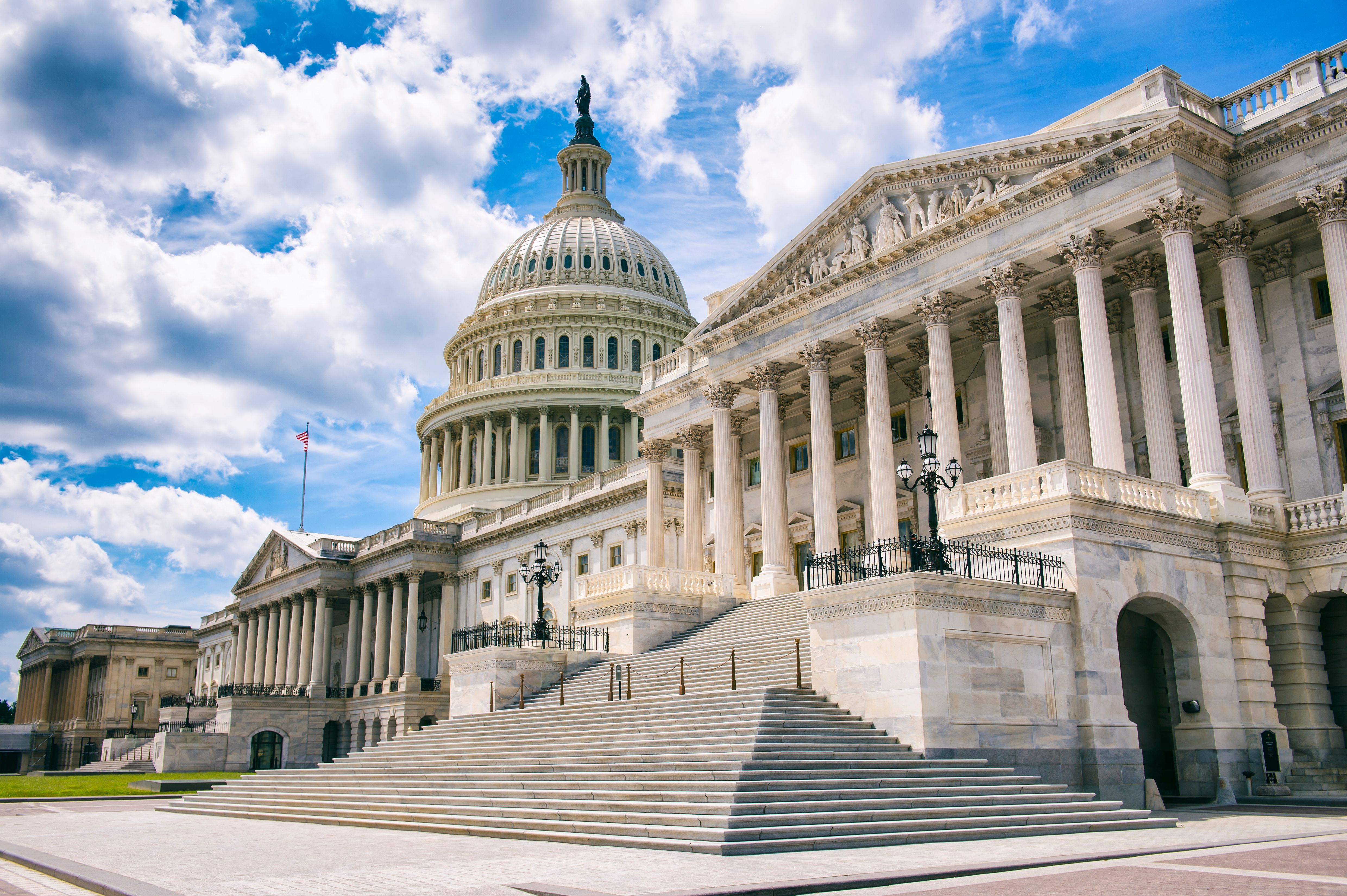 Bright mid-day view of the traditional neoclassical architecture of the Capitol Building’s dome, columns, and steps in Washington DC, USA - Image credit: lazyllama | stock.adobe.com 