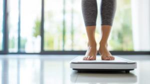 Barefoot Woman on Digital Scale Closeup - Monitoring Weight Loss, Female Fitness and Diet Lifestyle, Kilogram Display and Calorie Management Photo | Image Credit: forenna | stock.adobe.com