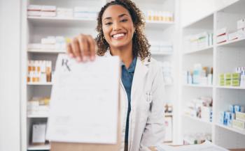 Female pharmacist handing prescription bag to a patient | Image credit: Rene La/peopleimages.com - stock.adobe.com