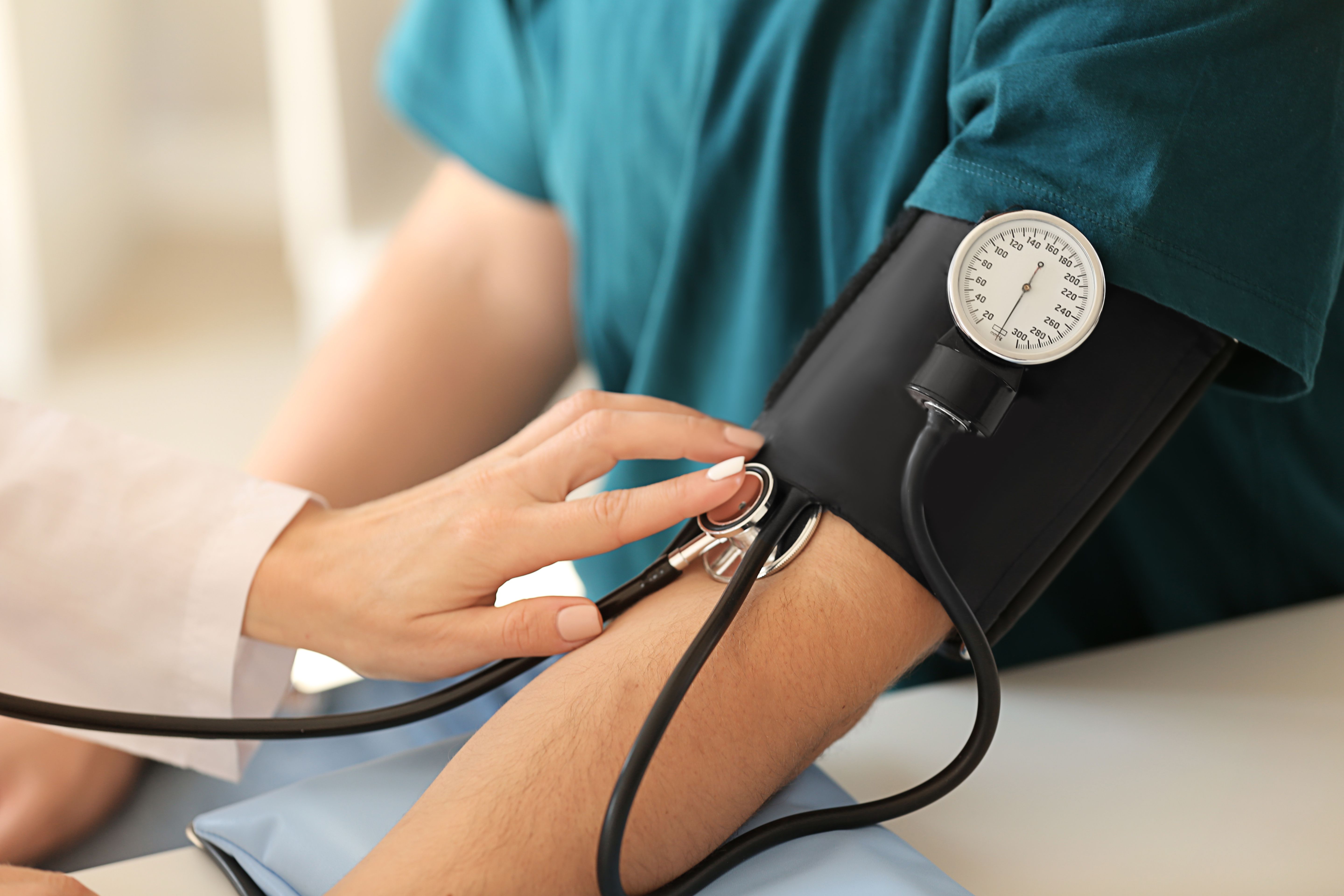 Female doctor measuring blood pressure of male patient in hospital | Image Credit: Pixel-Shot - stock.adobe.com