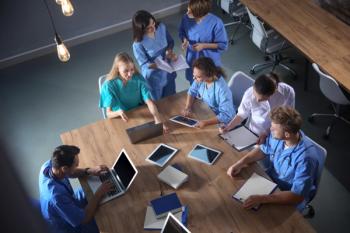 Group of medical students with gadgets in college, top view | Image Credit: © New Africa - stock.adobe.com