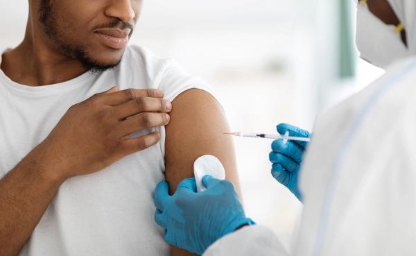 man receiving vaccine shot - Image credit: Prostock-studio | stock.adobe.com