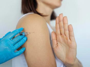 Woman Receiving Shoulder Injection While Raising Hand in Hesitation