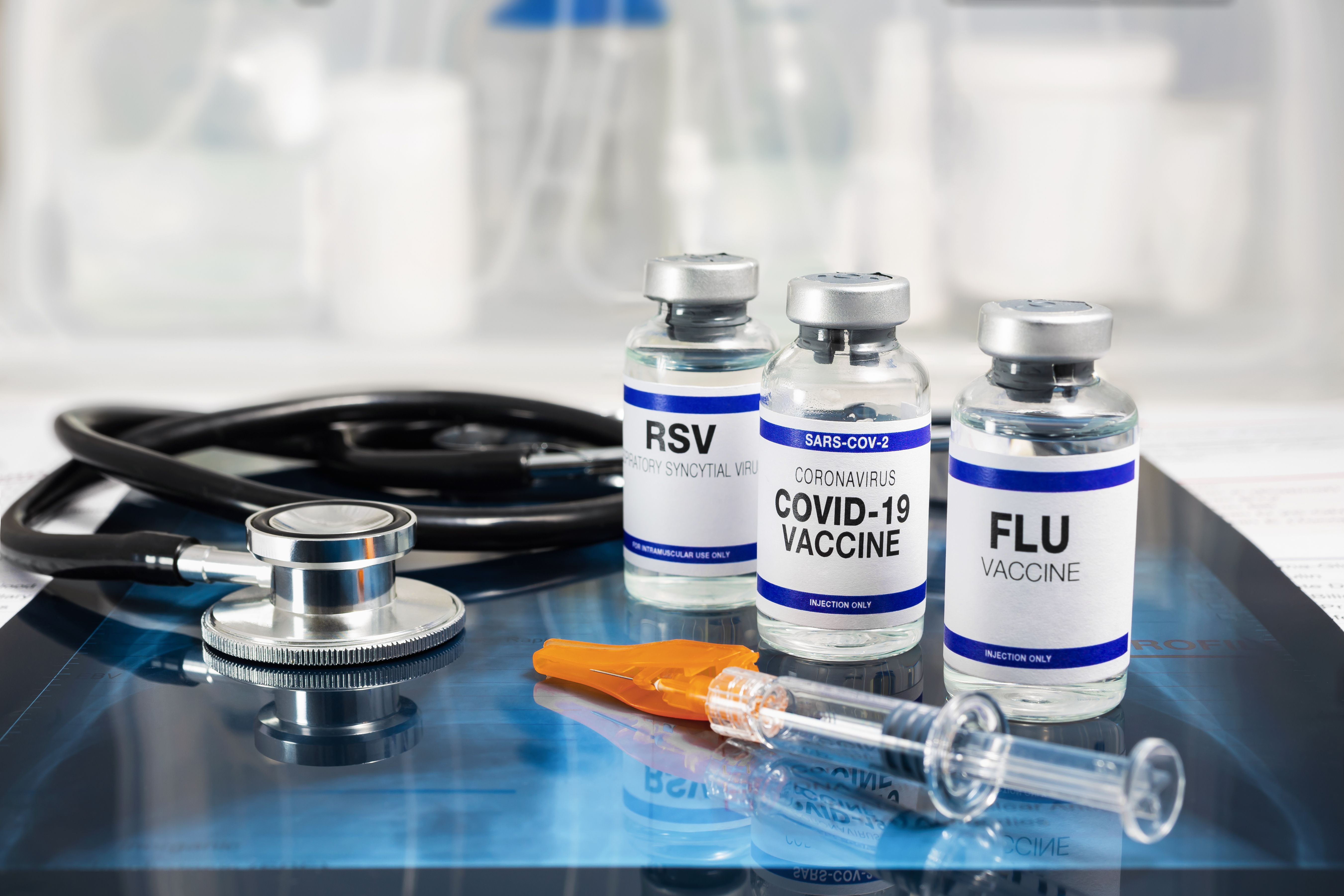 Bottles of vaccine for Influenza Virus, Respiratory Syncytial virus and Covid-19 for vaccination. Flu, RSV and Sars-cov-2 Coronavirus vaccine vials over Radiography pulmonar with stethoscope - Image credit: angellodeco | stock.adobe.com Bottles of vaccine for Influenza Virus, Respiratory Syncytial virus and Covid-19 for vaccination. Flu, RSV and Sars-cov-2 Coronavirus vaccine vials over Radiography pulmonar with stethoscope - Image credit: angellodeco | stock.adobe.com