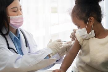 Asian doctor user syringe needle for injection vaccinate, African American children are being covid vaccinated for prevention coronavirus and flu. Concept of immunization from inoculation - Image credit: Prot | stock.adobe.com