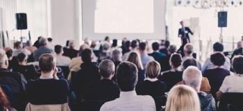 Speaker Giving a Talk at Business Meeting. Audience in the conference hall. Business and Entrepreneurship. Panoramic composition suitable for banners - Image credit: kasto | stock.adobe.com