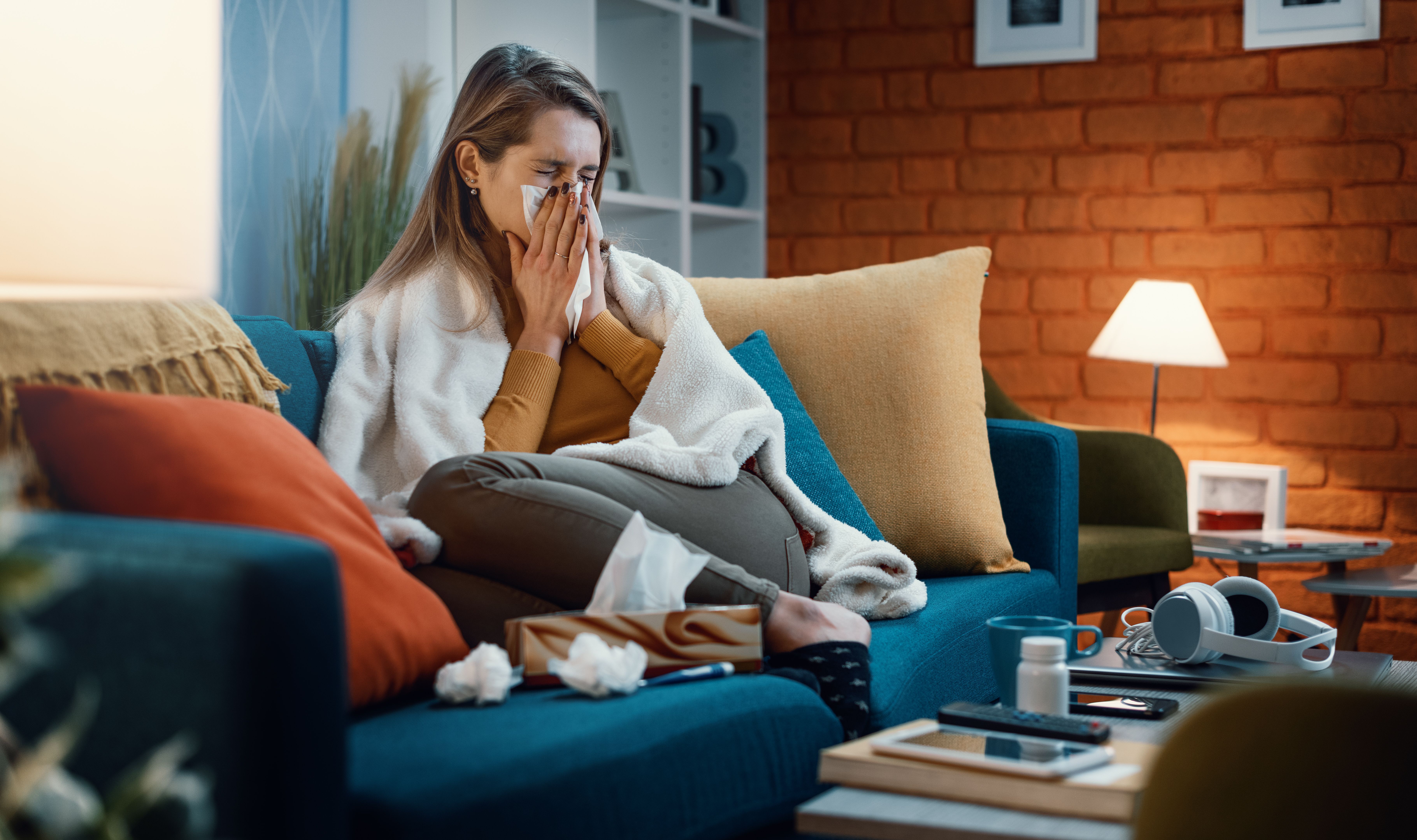 Woman with cold and flu blowing her nose | Image Credit: StockPhotoPro | stock.adobe.com