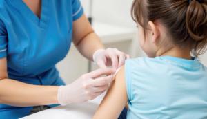 Kid with injury treated by nurse with bandage. A healthcare professional administers a vaccination to a young girl in a clinical setting, emphasizing care and health awareness