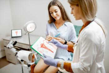 Gynecologist showing a picture with uterus to a young woman patient, explaining the features of women's health during a medical consultation in the office - Image credit: rh2010 | stock.adobe.com