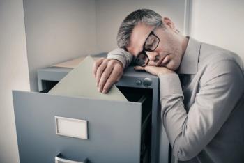Tired office worker sleeping in the office | Image Credit: StockPhotoPro | stock.adobe.com
