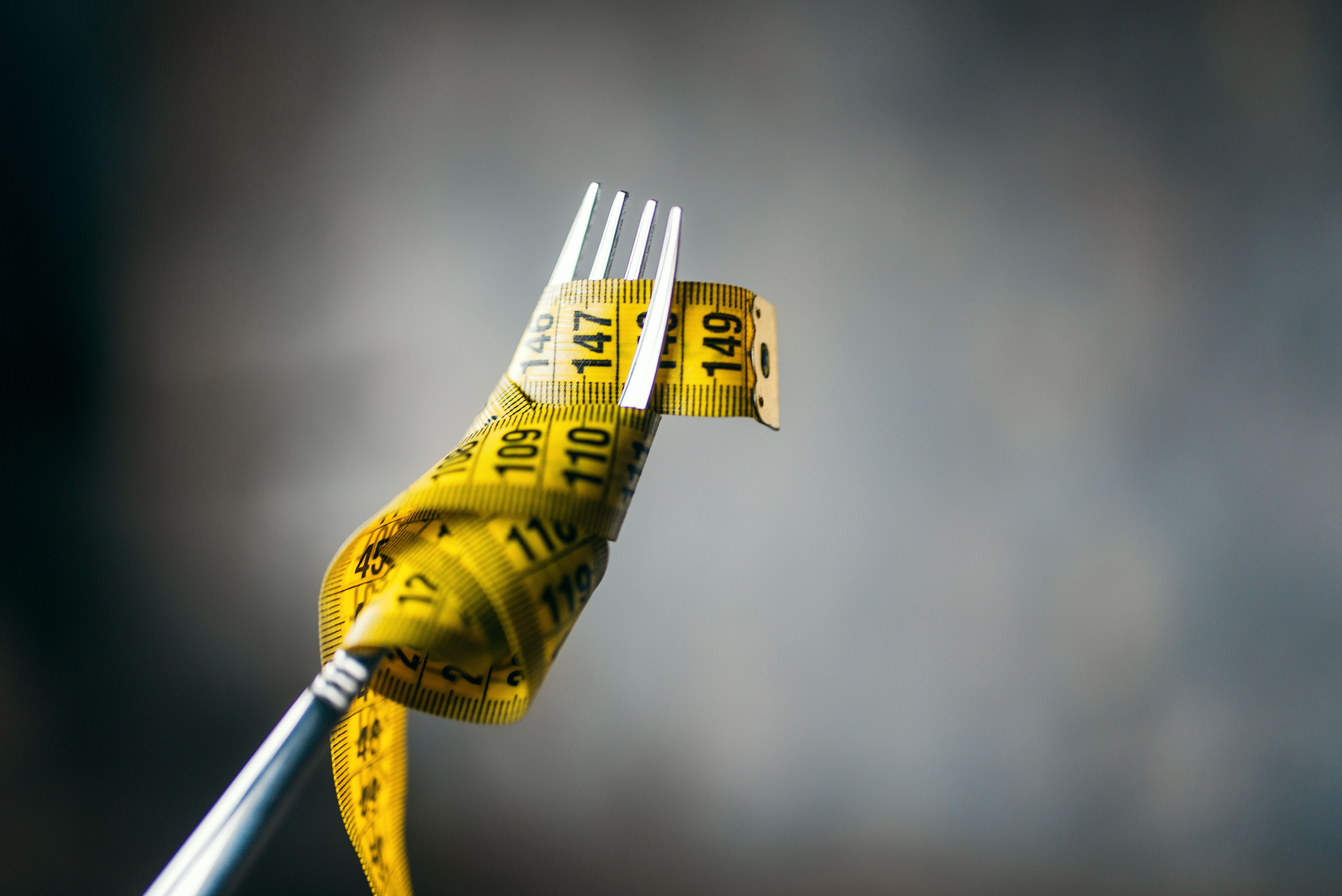 Measuring tape on a fork closeup, weight loss - Image credit: Nomad_Soul | stock.adobe.com