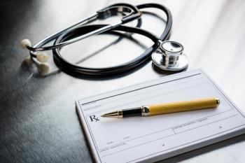 Prescription pad and a stethoscope on a desk