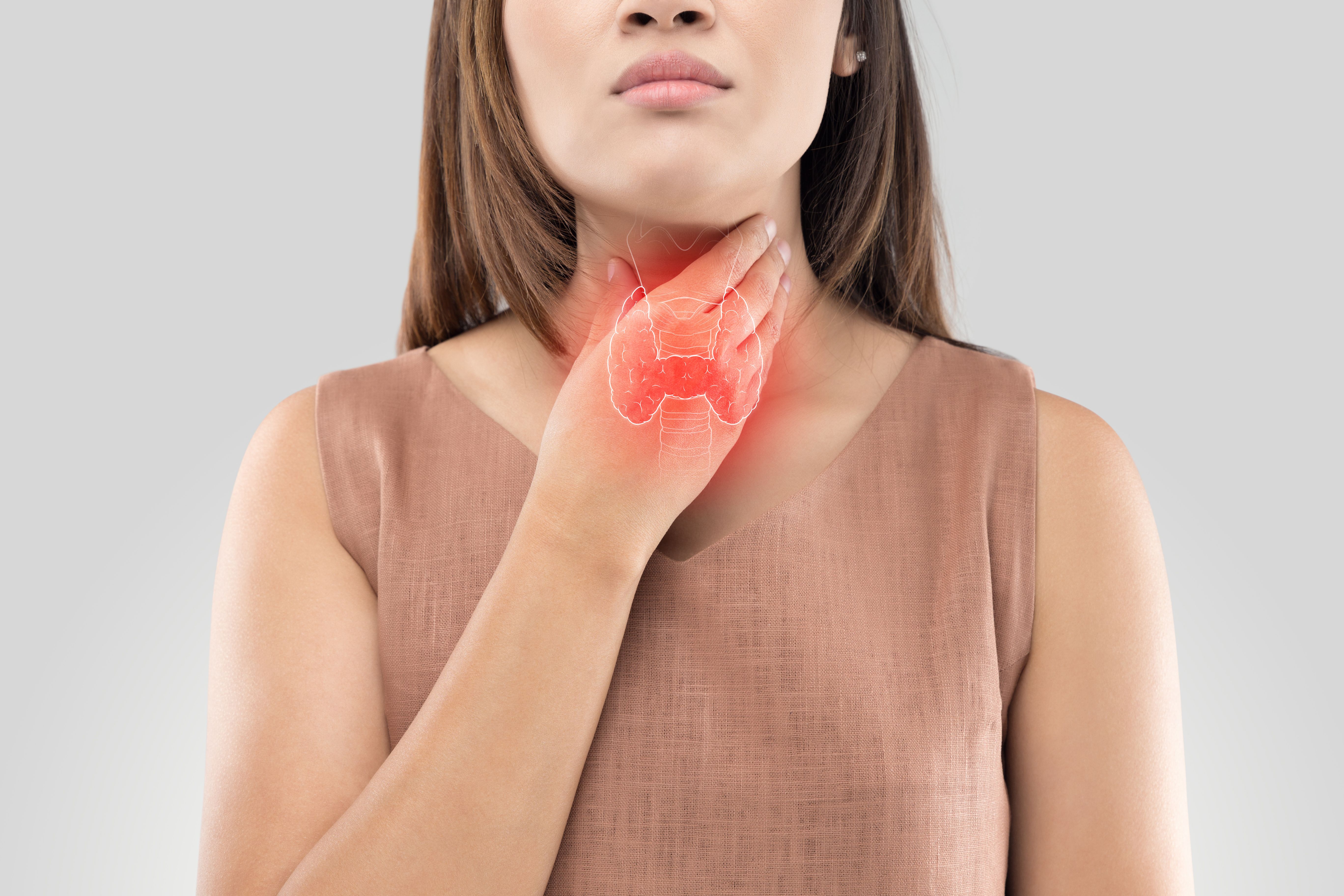 Woman checking her thyroid -- Image credit: eddows | stock.adobe.com