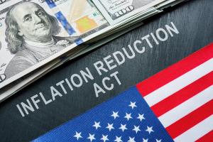 USA flag, dollars and inscription inflation reduction act. | Vitalii Vodolazskyi - stock.adobe.com