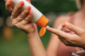Close-up image of a woman putting on sun lotion | Image Credit: ©  bnenin - stock.adobe.com