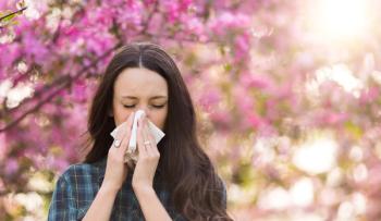 Woman blowing nose because of spring pollen allergy - Image credit: Budimir Jevtic | stock.adobe.com