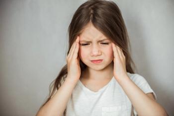 Child with a migraine -- Image credit: irena_geo | stock.adobe.com