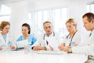 Physicians sitting around a table