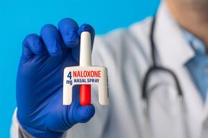 Close-up of a doctor holding a naloxone 4mg nasal spray in gloved hand. Concept of opioid overdose treatment and emergency medication in healthcare. | Image Credit: Dr MEK | stock.adobe.com