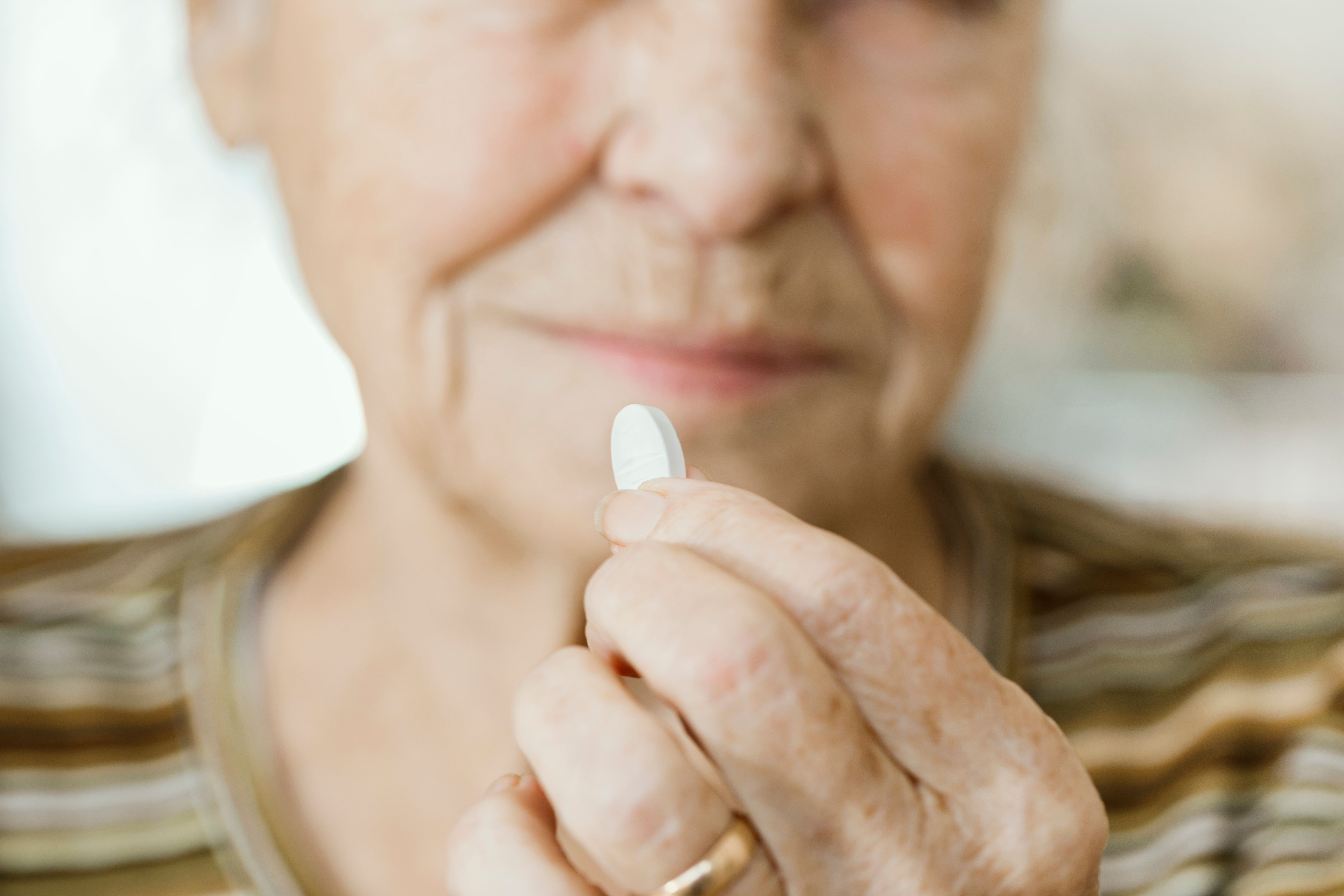 Woman holding oral nirmatrelvir and ritonavir treatment
