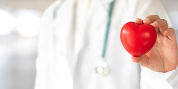 Cardiovascular disease doctor or cardiologist holding red heart in clinic or hospital exam room office for csr professional medical service, cardiology health care and world heart health day concept - Image credit: Chinnapong | stock.adobe.com