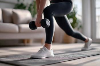 Sporty woman performing lunges with dumbbells, training legs and glutes on a mat in her living room - Image credit: Arfa_Media | stock.adobe.com