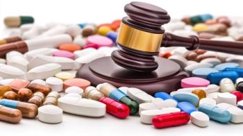 Close up image of colorful medicine pills and judge gavel on table. Medical law | Image Credit: Rose | stock.adobe.comconcept 