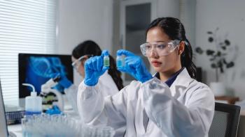 Scientist comparing two vials in laboratory research setting | Image Credit: ©Phimwilai -stock.adobe.com