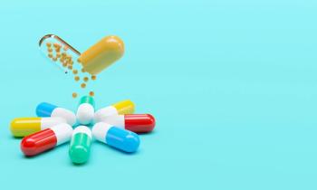 Capsules with granules background with copy space, can be used as medical mockup, template. 3D Rendering | Image Credit: © Waseem Ali Khan - stock.adobe.com