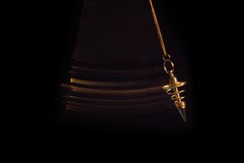 Pendulum used for readings and hypnotism swinging with motion blur | Image Credit: © fergregory - stock.adobe.com