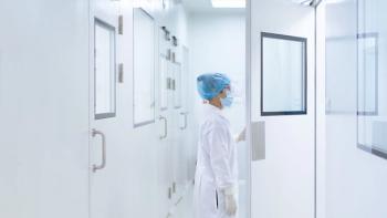 Unidentified microbiologist is open the cleanroom door to enter the room in clean area of microbial laboratory in pharmaceutical factory, concept of science, healthcare and safety operation. | Image Source: ©Sukjai Photo - stock.adobe.com
