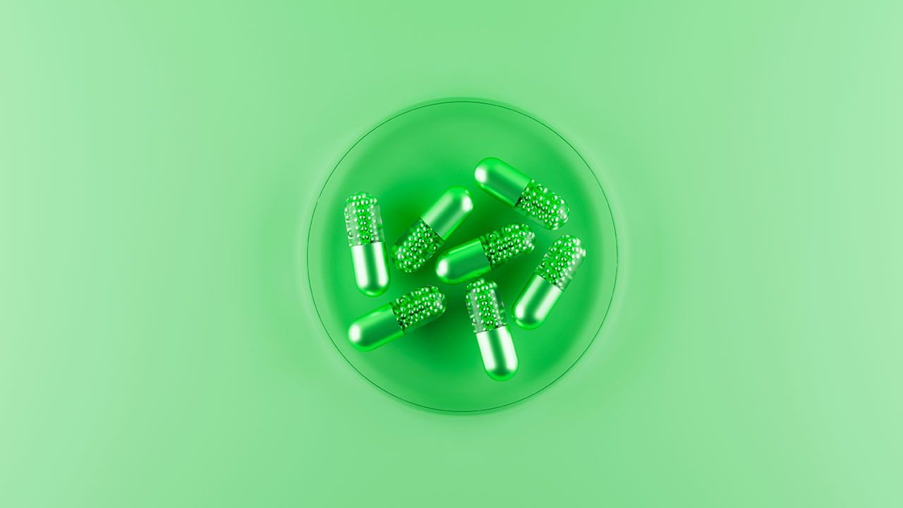 Medicinal capsules green pills in lab. Top view. 3d rendering | Image Credit: ©svitlini - stock.adobe.com
