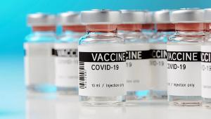 ampoules with Covid-19 vaccine on a laboratory bench. to fight the coronavirus / sars-cov-2 pandemic. | Image Credit: ©M.Rode-Foto - Stock.adobe.com