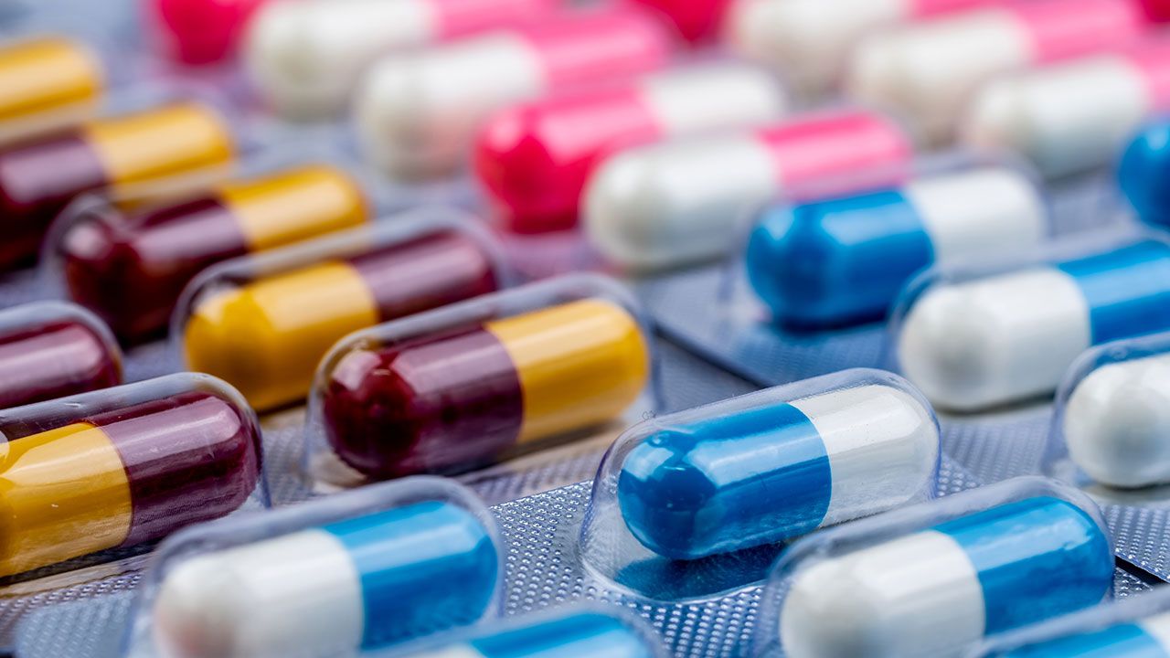 Selective focus on blue-white capsule pills in blister pack. Pharmaceutical industry. Drug package. Pharmaceutics concept. Drug use in hospital or drugstore product. Health budget. Global healthcare. | Image Credit: ©Artinun -stock.adobe.com