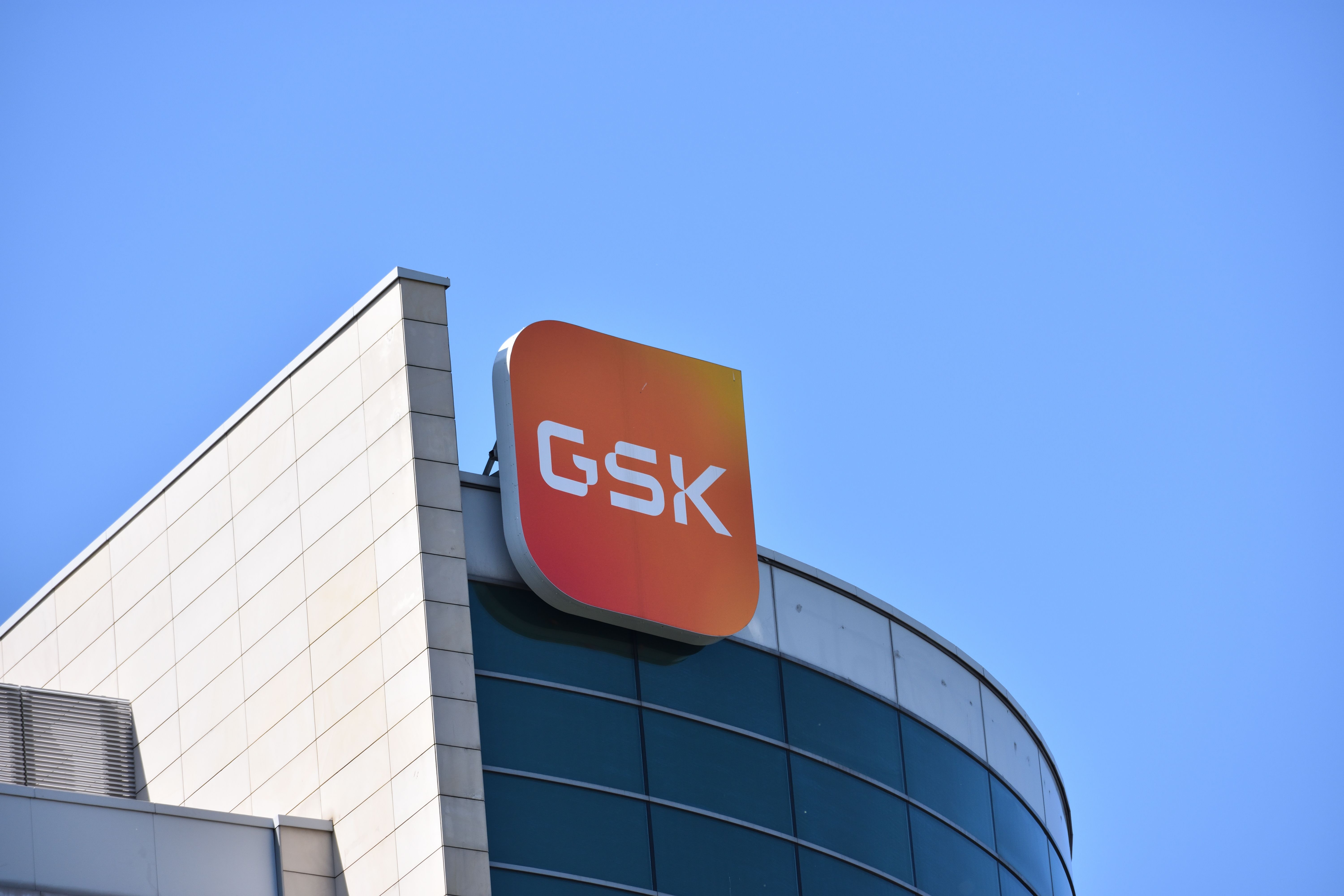 GSK signage, logo, emblem on the facade, British multinational pharmaceutical and biotechnology company. WARSAW, POLAND - JUNE 3, 2023 | Image Credit: © OlekAdobe - stock.adobe.com