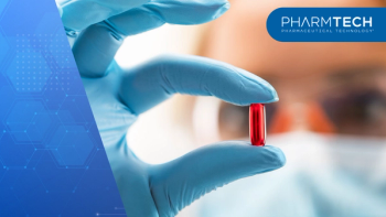 Young attractive female scientist holding a red transparent pill | Image Credit: ©Scanrail -stock.adobe.com
