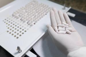 making white capsules. compounding pharmacy. compounding green medication. | Image Credit: © J. Balla Photography - © J. Balla Photography - stock.adobe.com