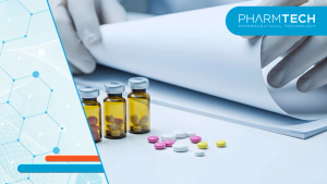 Scientist Examining Medical Documents Near Ampoules and Pills | Image Credit: ©PixelPulse-stock.adobe.com