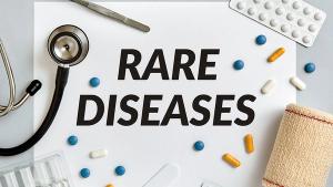 Rare diseases, medical concept surrounded by pills and medical supplies on gray background. Top view. | Image Credit:  ©maicasaa -stock.adobe.com