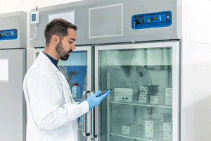 Scientist using tablet checking refrigerated drugs in pharmaceutical laboratory refrigerator | Image Credit: ©EDER -stock.adobe.com
