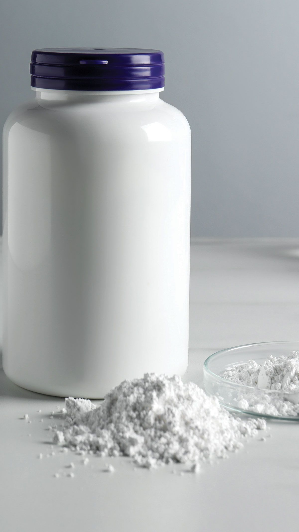 Calcium carbonate powder, jar and laboratory glassware on white marble table | Image Credit: ©New Africa - stock.adobe.com