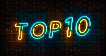 Top 10 neon blue and yellow light text on empty red brick wall banner. Bright sign of top ten list winners at night. Design template of modern signboard or advertising | Image Credit: © olhakibec - stock.adobe.com