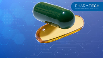 Green gelatin capsule resting on a translucent amber liquid drop, isolated on transparent background | Image Credit: ©Nina -stock.adobe.com
